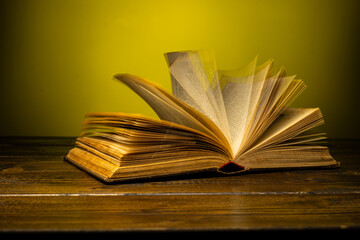 open book on a table on a gradient background with page turning