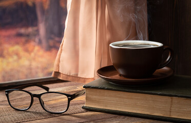 Obraz na płótnie Canvas Hot Cup of Coffee and Book