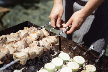 Cooking grilled kebab on metal skewer, fresh meat. Barbecue roasted meat