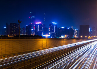 Fototapeta na wymiar Dubai, UAE - 06.04.2021 Light trails on Al Khail road at night. Urban
