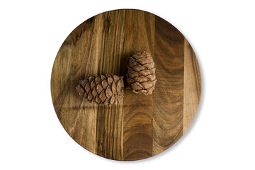 An old shredded wooden chopping board with cedar cones, isolated on a white background. Close-up of textured, top view