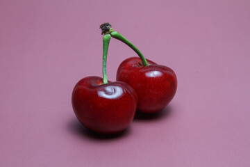 Fresh cherry on pink background.