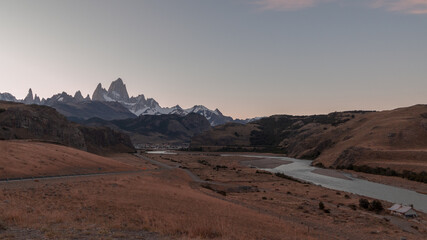 Sunset in the Mountains. El Chalten Road, Patagonia, Argentina. River de las Vueltas and Fiz Roy Mountain on a Evening Sky Background. Los Glacieres National Park. 
