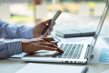 Financial Business man analyze the graph of the company's performance to create profits and growth, Market research reports and income statistics, Financial and Accounting concept.