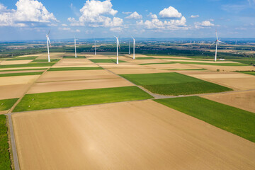 Bird's eye view of fields and meadows in Rheinhessen / Germany and wind turbines in the background