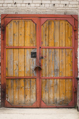 Old wooden plank door with metal frame and handles