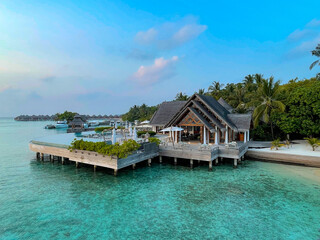 Amazing tropical Maldives island panorama. Beautiful beach and lagoon landscape background during sunrise.  Vacation, holiday and romantic honeymoon banner concept.