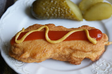 Homemade Corn Dogs with Mustard and Ketchup. red ketchup and yellow mustard on corn dog. 