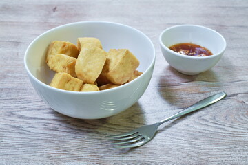 deep fried tofu dipping with sweet crushed bean sauce on plate