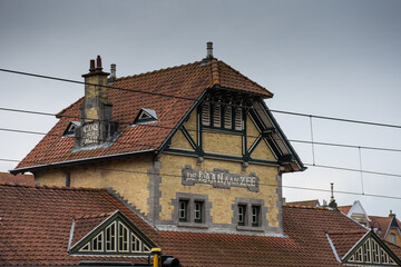 historic tram station in yellow brick and red roof in De Haan, Belgium