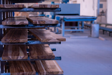 Obraz na płótnie Canvas shelf with teak wood awaiting drying after finishing in bernish in the industry