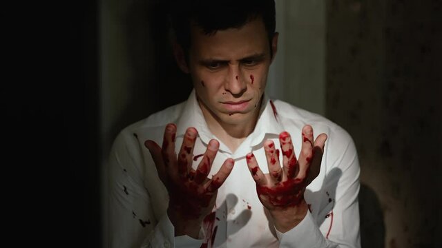 Murder looks at his bloody hands