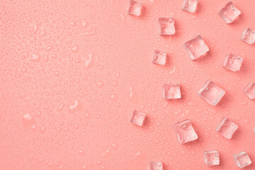 Top view photo of ice cubes on the right and drops on isolated pastel pink background with copyspace on the left