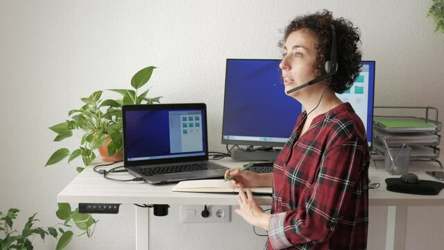 Woman telecommuting at an adjustable standing desk