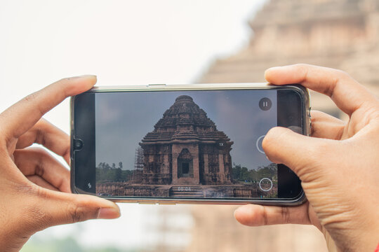 Taking photos on mobile at the Konark Sun Temple in India