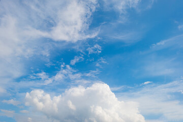 Naklejka na ściany i meble Clouds in a blue sky in bright sunlight in springtime, Voeren, Limburg, Belgium, June, 2021 