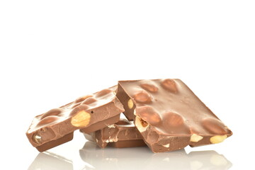 Several slices of dark chocolate with nuts, close-up, isolated on white.