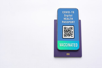 Modern Smartphone displaying a valid digital health passport for COVID-19 with copy space for text. Vaccination, qr code passport, safe traveling concept.