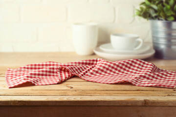 Empty wooden table with tablecloth over kitchen shelf background.  Interior mock up for design and...