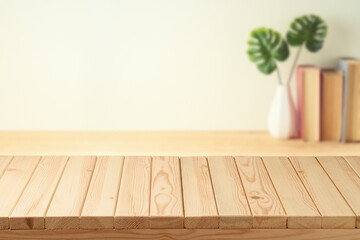 Empty wooden table over book shelf background.  Room interior mock up for design and product...