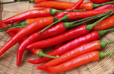 Close up the red hot peppers in the bamboo basket