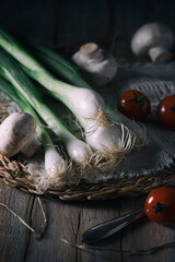 Fresh onions, mushrooms and tomatoes on a rustic table