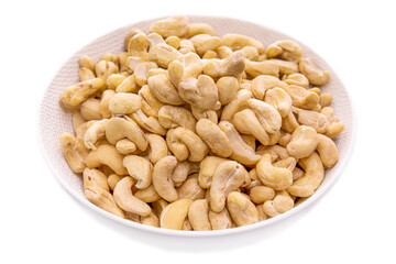 Cashews nuts in a white bowl close-up.isolated food products