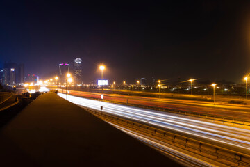 Fototapeta na wymiar Dubai, UAE - 06.04.2021 Light trails on Al Khail road at night. Urban