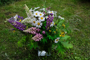 A bouquet of wild flowers, twigs and bent, prepared for the solstice festival decoration