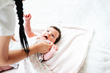 mom wipes baby's burp from her lips after feeding