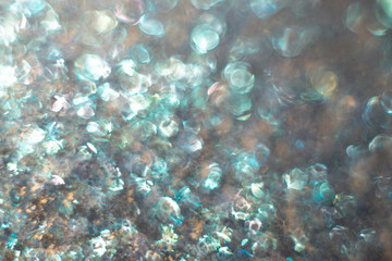 Fototapeta na wymiar turquoise agitated water with worm sun reflections
