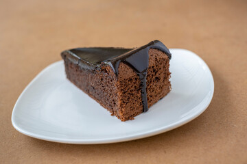 Slice of chocolate cake on white plate