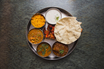 Typical curry set meal of meals south India with Chicken Tandoori, Mutton Curry, Subji (Vegetarian Curry),Papadum,Nan,Raita (Yogurt with cucumber),Mutter Paneer ,and Pulao Rice