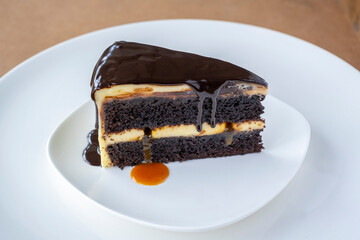 Slice of caramel chocolate cheese cake on white plate