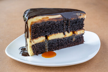 Slice of caramel chocolate cheese cake on white plate