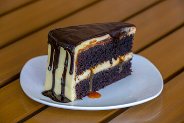 Slice of caramel chocolate cheese cake on white plate
