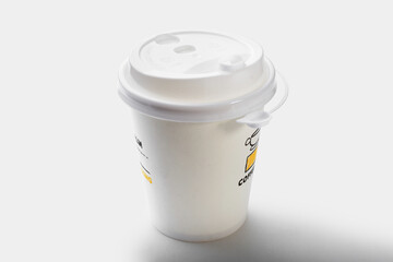 A white glass for hot drinks. Coffee cup for insulation.