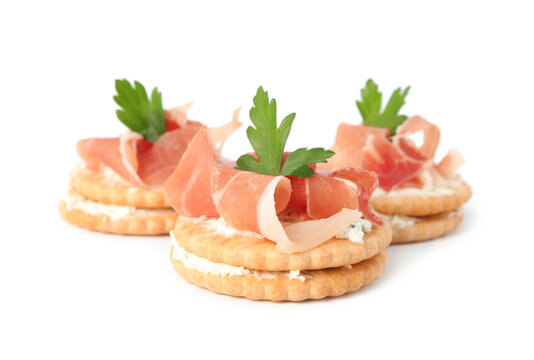 Delicious Crackers With Cream Cheese, Prosciutto And Parsley On White Background