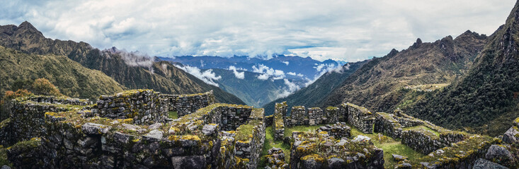 Fototapeta na wymiar Panoramic human view of the valley on Phuyupatamarca ruins. Inca trail to Machu Picchu archaeological site from the Inca's ancient civilization in Peru. South America