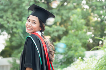 happy smiling college student in commencement day, concept of successful education, happy graduation, woman education equality, study abroad, high education degree, overseas study scholarship