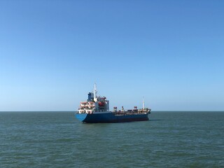 a tanker ship is anchored in harbor area