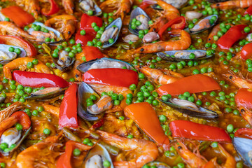 Spanish seafood paella in fry pan with mussels, shrimps and vegetables