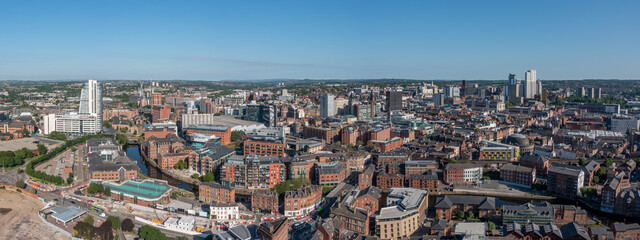 Leeds city centre Yorkshire, England. Aerial view from a drone overlooking the armouries and river towards the retail, offices and apartments on a sunny day. 