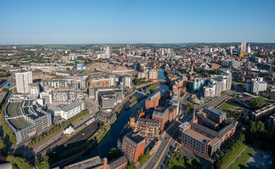 Fototapeta na wymiar Leeds city centre Yorkshire, England. Aerial view from a drone overlooking the armouries and river towards the retail, offices and apartments on a sunny day. 
