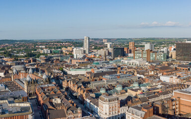 Fototapeta na wymiar Leeds City Centre in Yorkshire. Aerial view of the retail shopping area, offices and hotels looking south on a sunny day to Bridgewater place and the train station. 