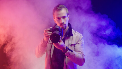Creative professional photographer in colorful smoke