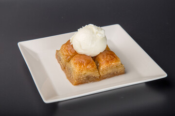turkish baklava and ice cream sweet white 

plate black background