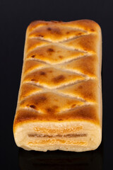 (Pan de Cadiz) Typical sweet from Andalusia, Spain. Baked dessert of marzipan dough filled with candied fruit. Vertical shot and selective focus.