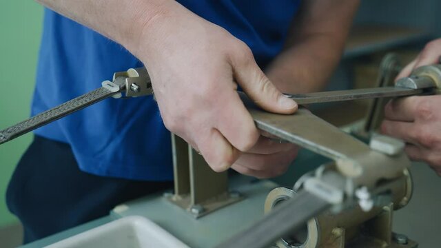 The workers of the enterprise conduct tests on the test bench. Close-up of workers ' hands