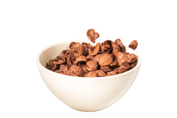 Chocolate corn flakes falling to the white bowl isolated on white. Motion.
